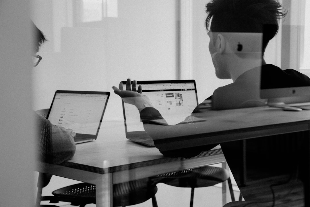 2 people working together with laptops